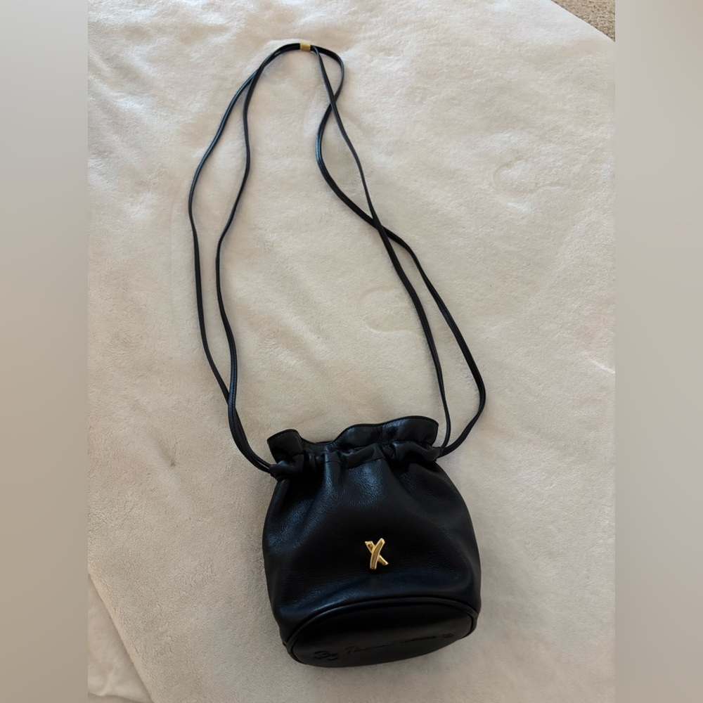 Paloma Picasso black leather drawstring crossbody bag with gold detail